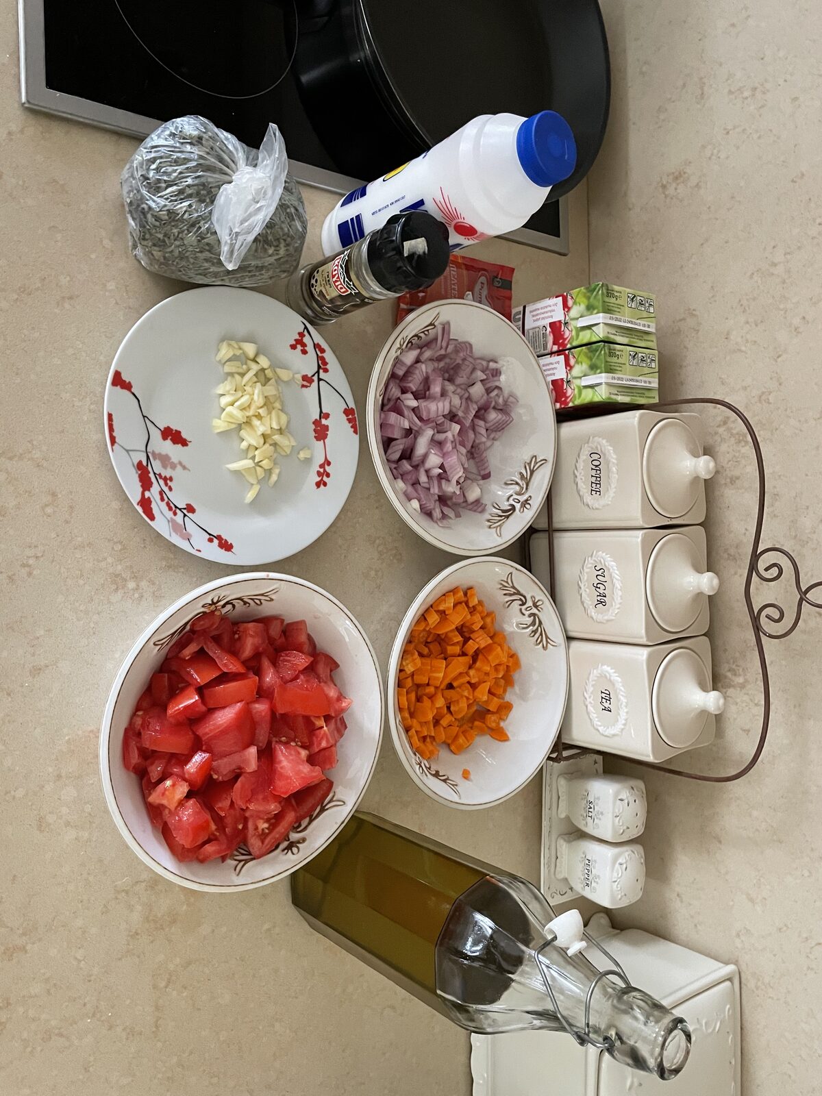 The full spread: shallots, paprika, carrots, garlic, fresh tomatoes, olive oil, fresh basil